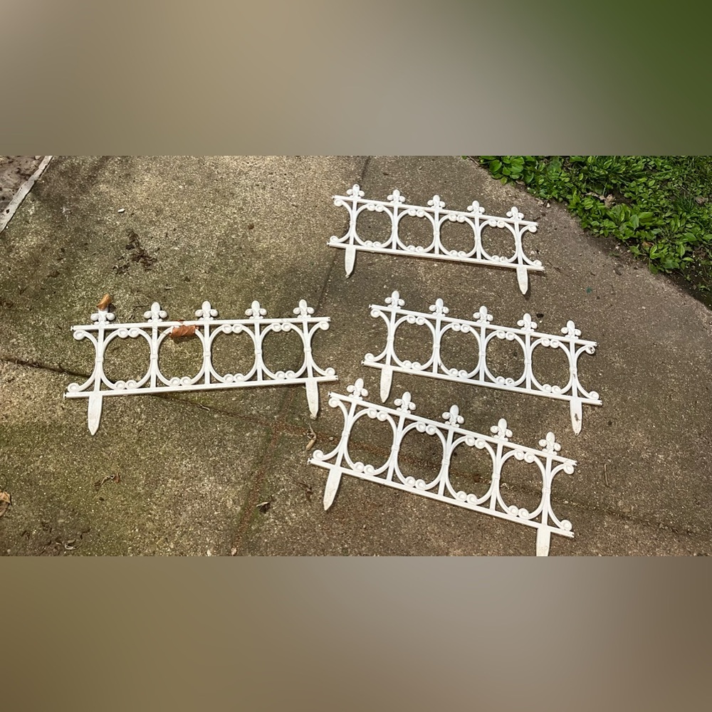 Four pieces of white garden fencing